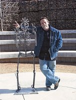 Gilbert McCann, by his 'flower-child' sculpture
